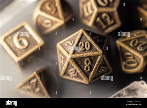 Close Up Image Of A Set Of Copper Role Playing Dice Surrounded By Smoke