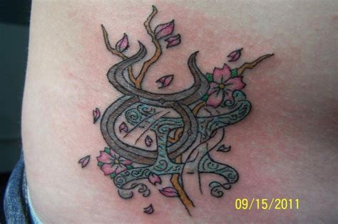 Taurus With Gemini Tattoo On Side Rib Flowers Tattooshuntcom Taurus