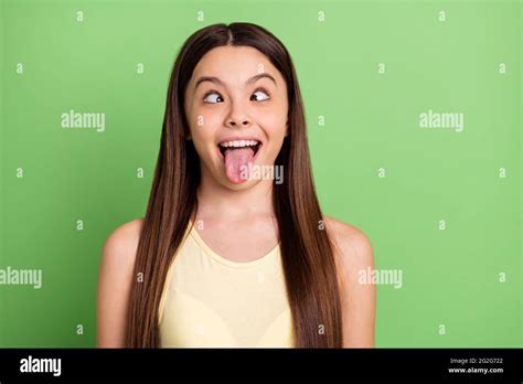 portrait of excited carefree person squint eyes tongue out have fun isolated on green color