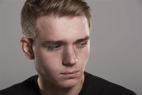 Sad Young White Man Looking Away Head And Shoulders Stock Photo