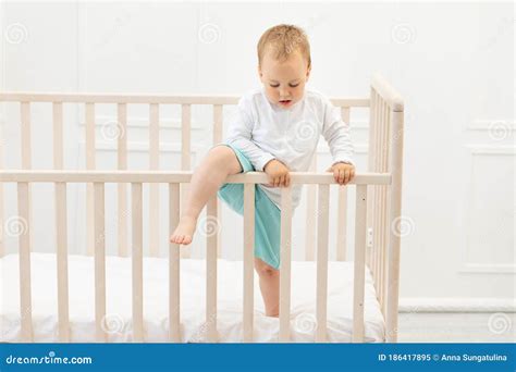 Baby Climbs Out Of The Crib Baby Boy 2 Years Old In The Crib Stock