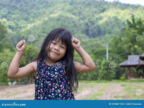 portrait of sweet adorable little asian girl with black hair smiling