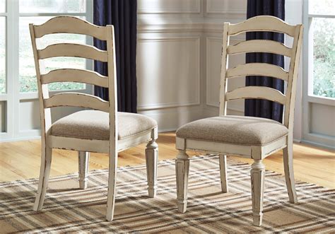 The most common wood dining room chairs material is wood. Realyn 2 Chipped White Upholstered Dining Chairs ...