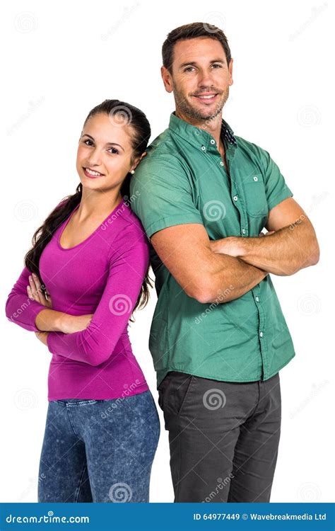Smiling Couple Standing Back To Back With Arms Crossed Looking At The Camera Stock Image Image