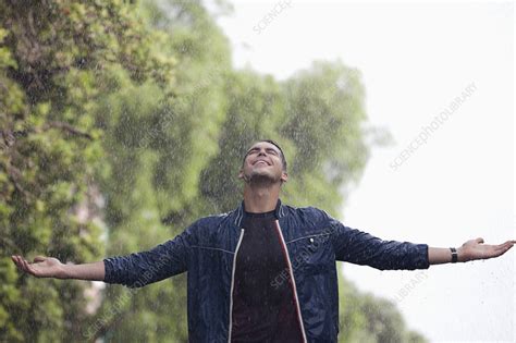 Man With Arms Outstretched In Rain Stock Image F Science Photo Library