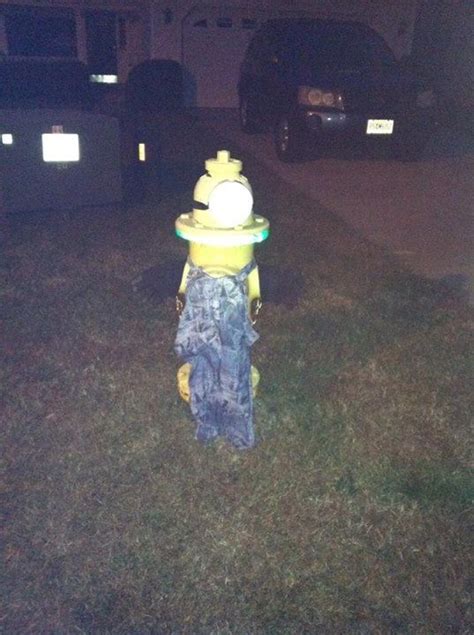 A Yellow Fire Hydrant Sitting In The Middle Of A Grass Covered Field At