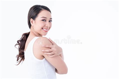 Pretty Woman Applying Nourishing Cream On The Skin Around Her Shoulder