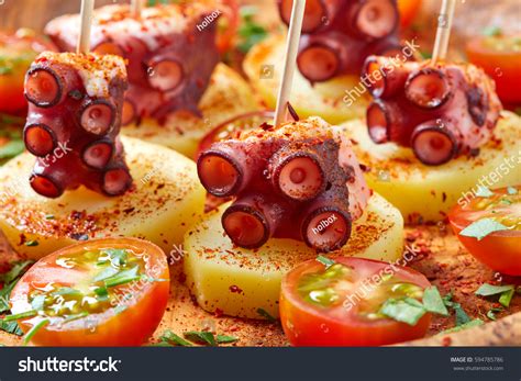 Picada is a type of tapas eaten in argentina and uruguay, usually involving only cold dishes, such as olives, ham, salami, mortadella, bologna, different types of cheese, marinated eggplants and red pimentos, sardines, nuts, corn puffs, fried wheat flour sticks, potato chips, and sliced baguette. Galician Octopus La Gallega Tapas Pinchos Stock Photo ...