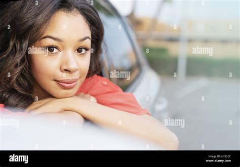 Pretty Young Woman Leaning Out Of Car Window Stock Photo Alamy