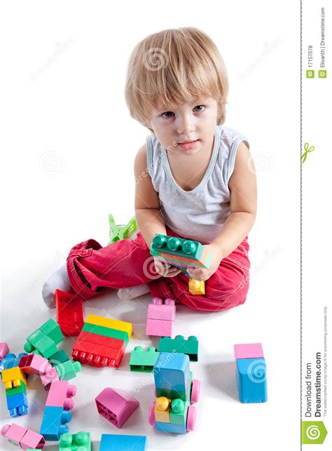 Little Boy Playing With Colorful Blocks Stock Photo