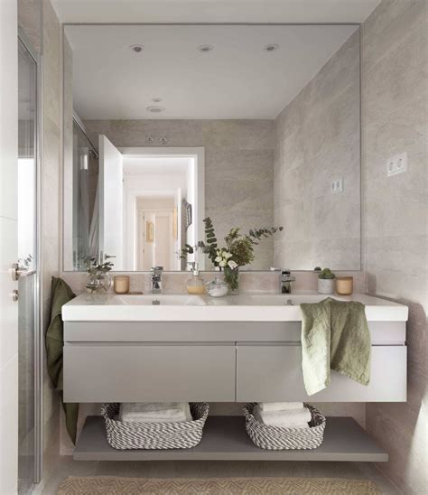 A Bathroom With A Sink Mirror And Towels On The Rack In Front Of It