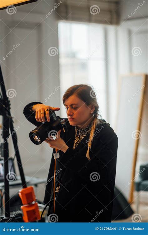 Portrait Of A Female Professional Photographer Standing In A Photo