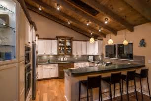 Farmhouse kitchen with beam ceilings. Spacious Kitchen With Country Accents and Vaulted Wood ...