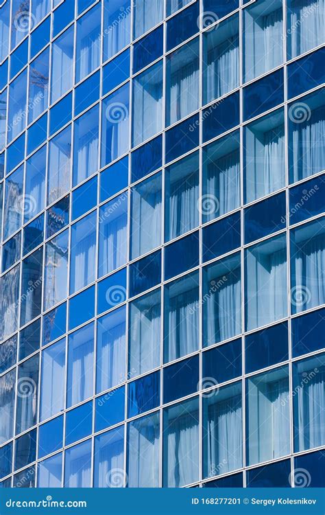 Reflection In Blue Glass Wall Of An Modern Office Building Stock Image