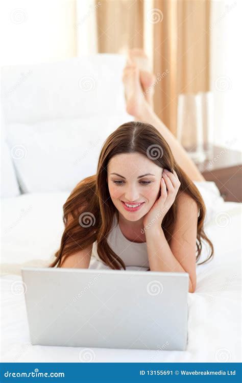 Enthusiastic Woman Using A Laptop Lying On Bed Stock Image Image