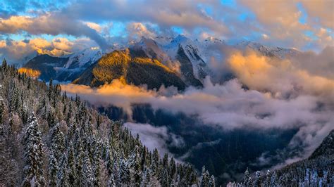 Beautiful Clouds Under Dark Forest With Snow Covered