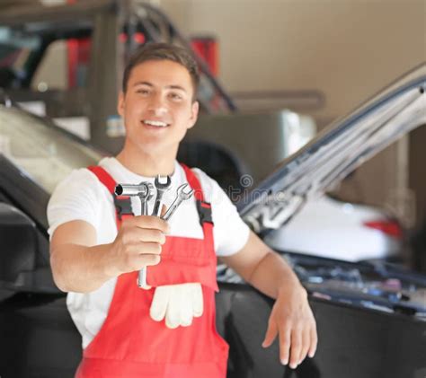 Young Auto Mechanic With Tools Near Car In Service Center Stock Image
