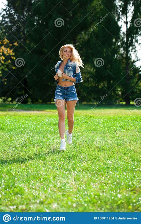Beautiful Blonde Woman Dressed In A Denim Jacket And Shorts Stock Photo Image Of Clothes