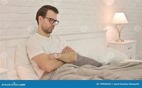 Drowsy Young Man Falling Asleep Sitting In Bed Stock Footage Video Of