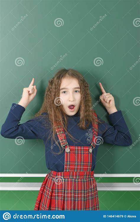 Schoolgirl Near Green School Board Young Playful Girl Shows A Finger Up Stock Image Image Of