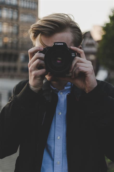 Young Man Taking Photo With Digital Camera Stock Photo People Stock