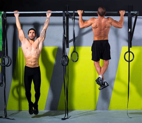 Premium Photo Crossfit Toes To Bar Men Pull Ups 2 Bars Workout