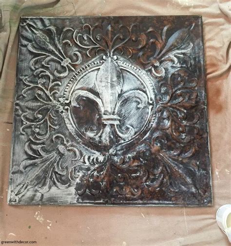 Once the metal has dried, dampen a cloth with white vinegar and wipe the surface down. how-to-paint-metal-diy-wall-decor-painting - Green With Decor