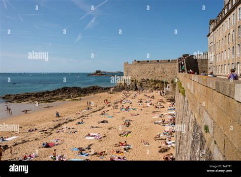 Tourist Walking On Ramparts Of Intra Muros Saint Malo And People On