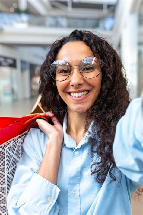 Beautiful Hispanic Woman Looking Into Smartphone Camera Talking On Video Call And Taking Selfie