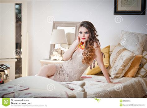 Young Beautiful Woman In White Short Tight Dress Posing