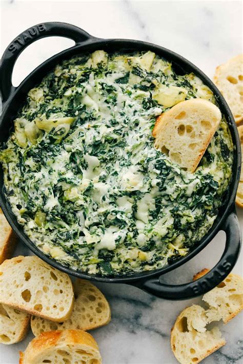 Hot spinach artichoke dip is a creamy appetizer dip filled with soft cream cheese, shredded spinach, chopped artichokes all melted together in a cheesy mixture blend and baked hot and bubbly in a skillet that is ready for dipping. Hot Spinach Artichoke Dip | The Recipe Critic
