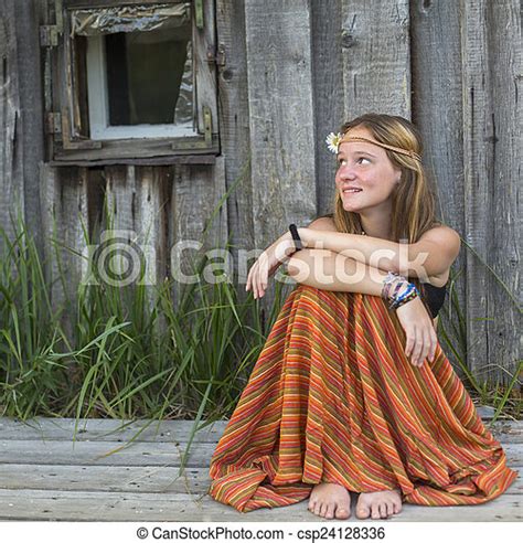Young Hippies Girl Sitting Outdoors In The Countryside Looking Blank
