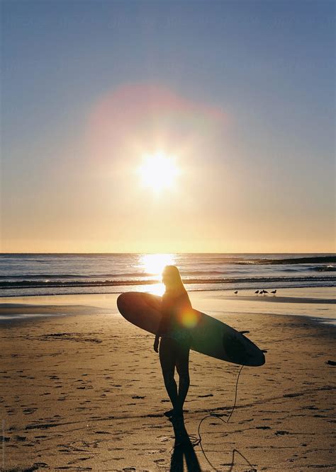 Girl In Bikini Walking Beach With Surfboard On Her Head Sun Flare