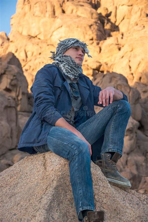 Man In A Keffiyeh Sitting On A Rock In The Desert Stock Image Image