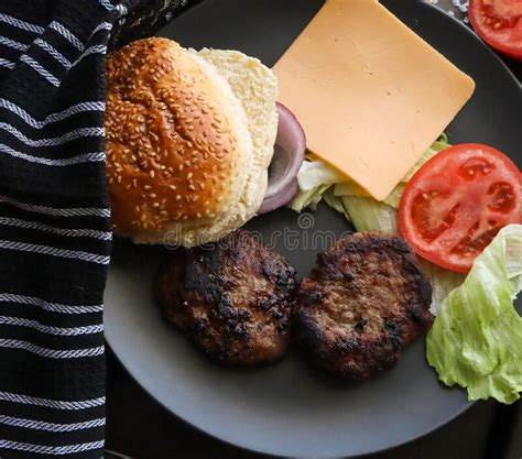 Chargrilled Beef Burgers With Lettuce Tomato And Onion With Cheddar