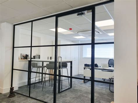 industrial style black framed glass screen supplied and installed for decora mouldings in