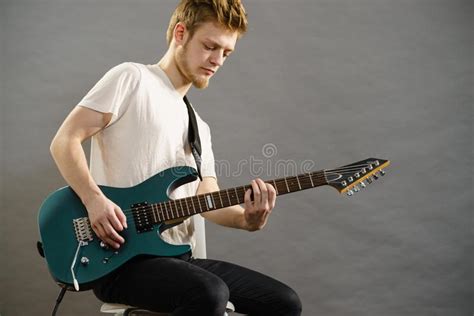 Here, we investigate a handful of the pedals that play a major role in shaping the sound of the blues. Young Man Playing Electric Guitar Stock Photo - Image of ...
