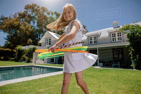 Happy Babe Girl Playing With Hula Hoop In The Backyard Smiling Girl Playing Outdoors On A
