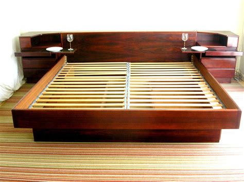 King Size Rosewood Platform Bed With Attached Nightstands ... Nightstands are unsung heroes of the night, keeping your books, alarm clock and glass of water within reach.