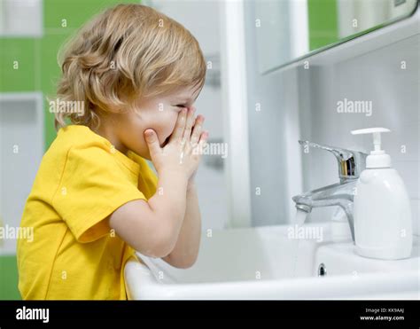 Child Boy Is Washing His Face In The Bathroom Stock Photo 166777482