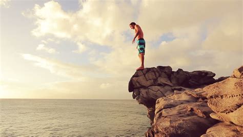 Young Man Jumps Off Cliff Stock Footage Video 100 Royalty Free 12859034 Shutterstock