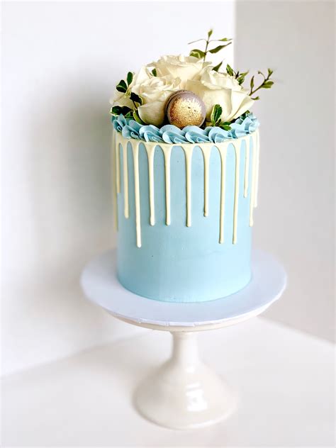 Baby Shower Blue Cake Featuring White Blooms And White Drip Blue Drip