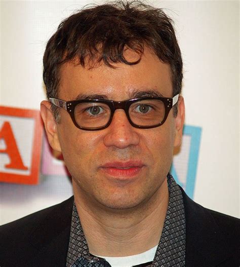 A Man Wearing Glasses And A Suit Jacket