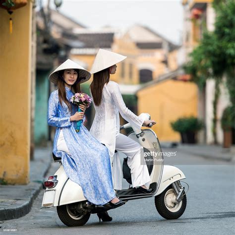 vietnam-young-women-sitting-on-classic-scooter-high-res-stock-photo