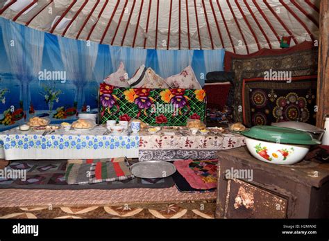 Interior Of A Yurt With Stove And Long Table Set For Lunch Guests Stock