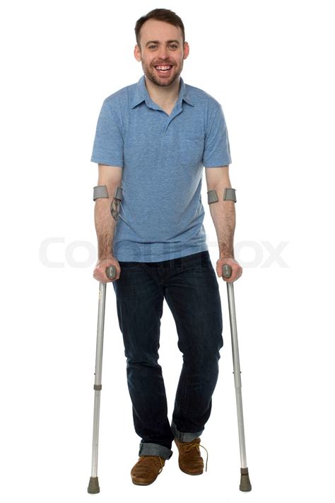 Smiling Young Man Using Crutches Stock Image Colourbox