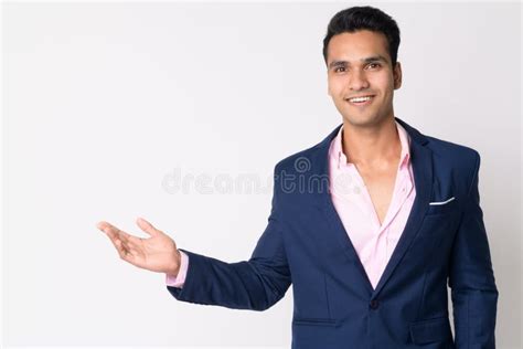 Portrait Of Young Happy Indian Businessman In Suit Showing Something