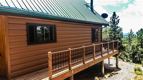 Metal siding and cladding installation company. Green metal roof with Cedar log siding! | Log siding ...