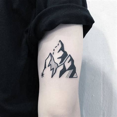 In fact, you really can't go wrong for instance, an upper arm tattoo may be hidden at work, with the option of letting your artwork go up. Black minimalist tattoo of a mountain inked on the upper side of the right arm | Blackwork ...