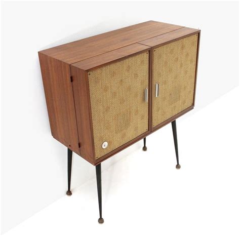Inside, craftsmen use machines to cut wood. Midcentury Cabinet Stereo Record Player by Philco, 1950s ...